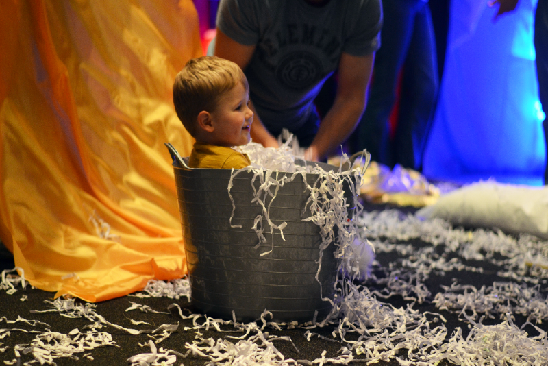 Toddler having fun in a bucket